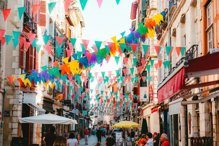 photo of assorted-color buntings placed on buildings during daytime
