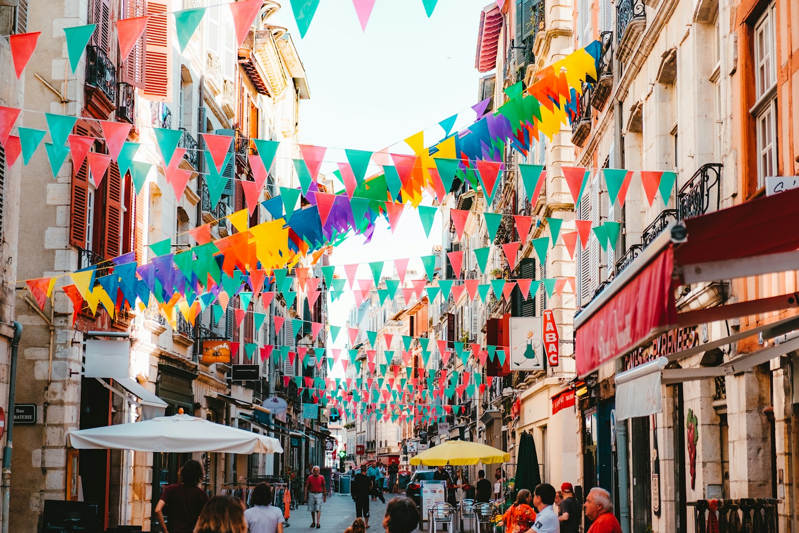 photo of assorted-color buntings placed on buildings during daytime